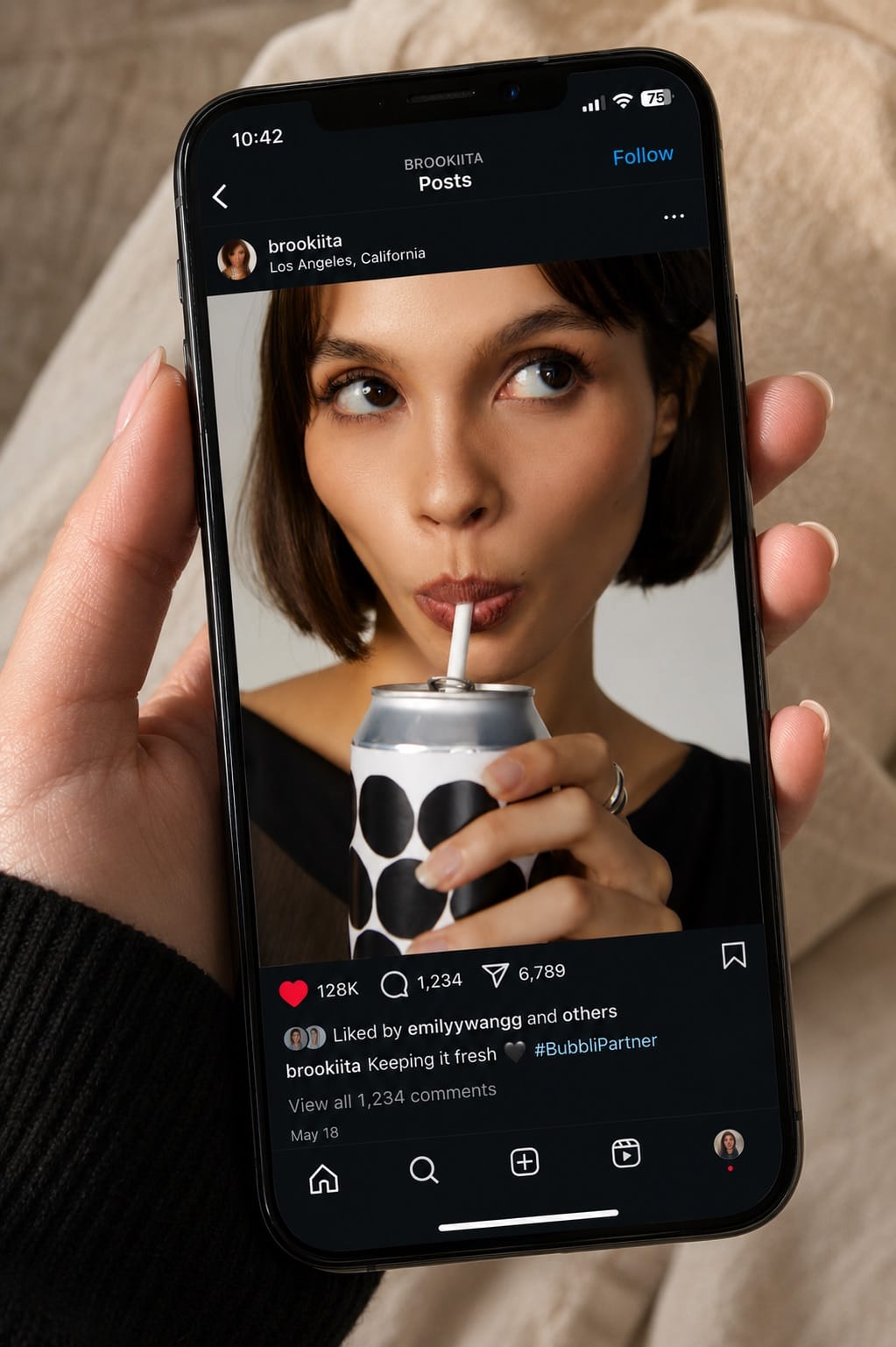 A phone displaying a finished social post from a brand campaign